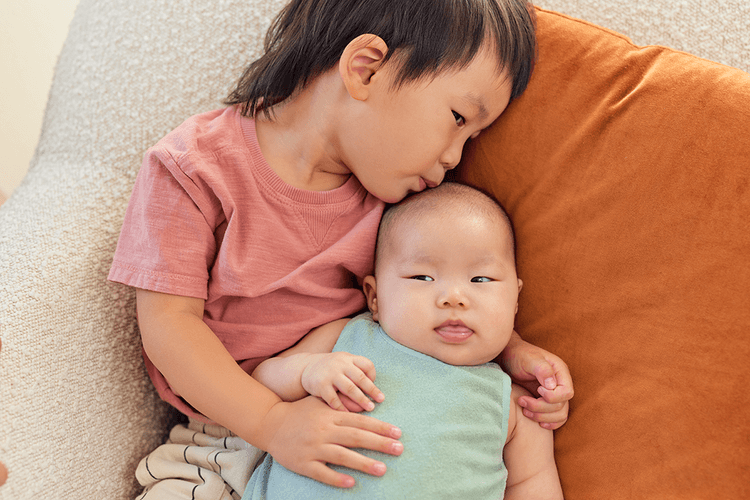 Siblings laying with each other