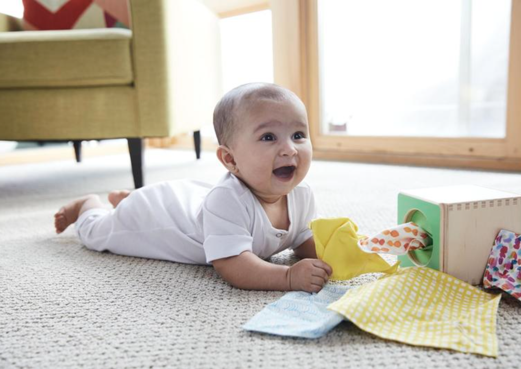 Baby pulling tissues from the Magic Tissue Box from The Senser Play Kit