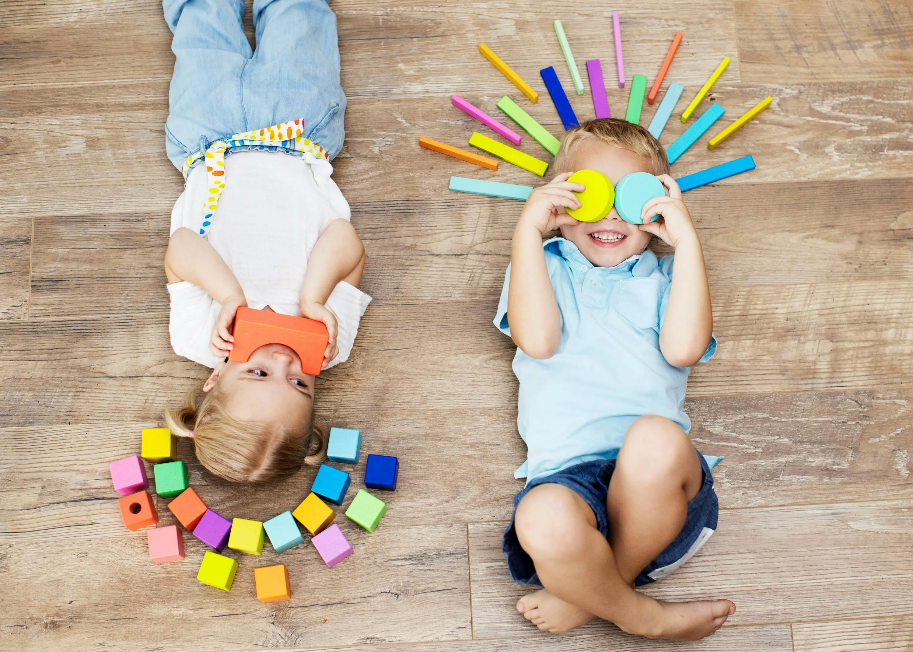Two children laying with blocks from The Block Set