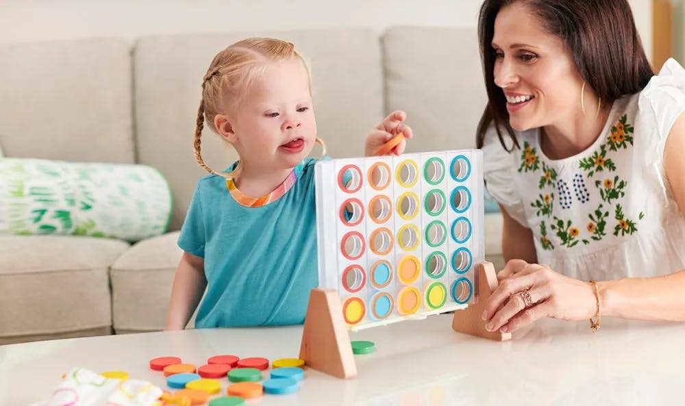 Child playing with the Drop & Match Dot Catcher from The Helper Play Kit