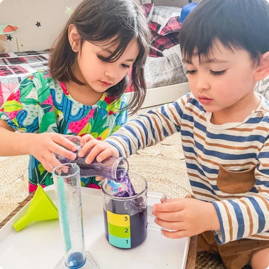 Two children using the Liquid Lab from The Investigator Play Kit