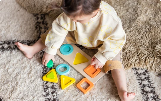 Child with the Geo Shapes Puzzle from The Realist Play Kit