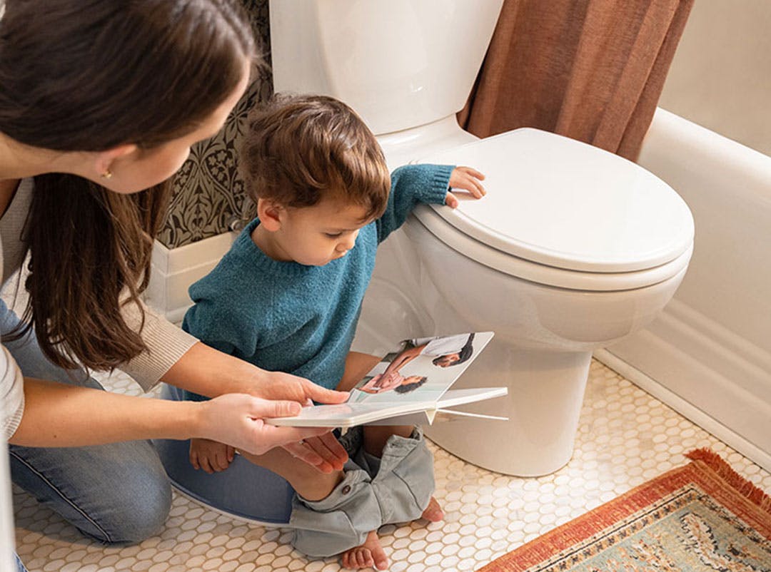 Child reading while using the potty